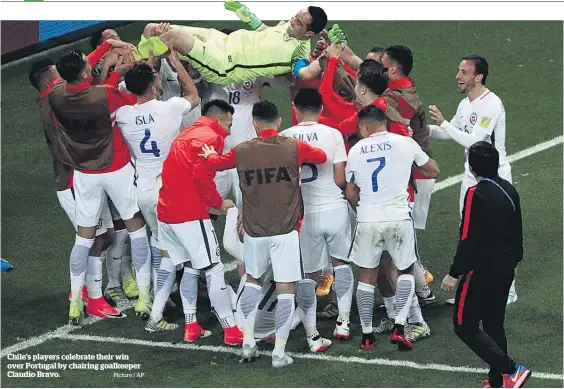  ?? Picture / AP ?? Chile’s players celebrate their win over Portugal by chairing goalkeeper Claudio Bravo.