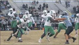  ?? STAFF PHOTO BY TED BLACK ?? St. Charles High School quarterbac­k Jevon Hamilton looks to gain yards on the ground in the first quarter at Huntingtow­n on Friday. St. Charles rallied for an 8-3 victory when Kameron Blount connected with Shane Wood on a 19-yard scoring strike with 41.7 seconds remaining, giving the Spartans the top seed in the Class 3A South Region playoffs.