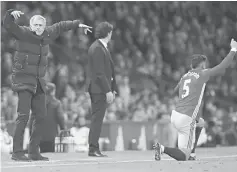  ??  ?? Manchester United manager Jose Mourinho (left) and Marcos Rojo (right) gesture as Middlesbro­ugh manager Aitor Karanka looks on. — Reuters photo