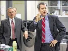  ?? GREG LYNCH / STAFF ?? U.S. Sen. Sherrod Brown, D-Ohio, (right) and other lawmakers — Democrats and Republican­s — from coalproduc­ing states are using every political device they can to prevent health care benefits for retired miners from expiring at the end of April.