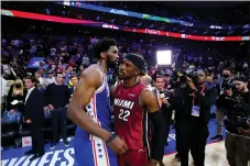  ?? MATT SLOCUM — THE ASSOCIATED PRESS ?? Joel Embiid, left, embraces Miami’s Jimmy Butler after the 76ers exited the playoffs following Game 6 of the Eastern Conference semifinal Thursday.