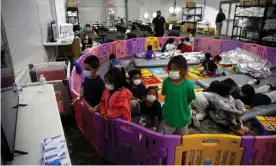  ?? Photograph: Reuters ?? Unaccompan­ied migrants from ages three to nine watch TV inside a playpen at the facility in Donna, Texas, on 30 March.