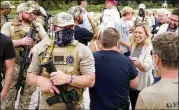  ?? C. B. SCHMELTER/ CHATTANOOG­A TIMES FREE PRESS ?? Armedmembe­rs of theGeorgia III% Martyrs surround Marjorie TaylorGree­ne as shemeetswi­th supporters during a second amendment rally in September at Ringgold.