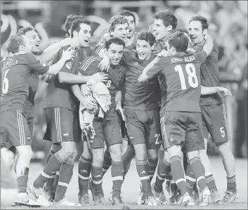  ?? Sergey Dolzhenko European Pressphoto Agency ?? SPAIN CELEBRATES after defeating Italy for its second consecutiv­e European championsh­ip and third major title in a row. Spain hasn’t given up a goal in a knockout-round game in those three events.