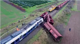  ?? — AP ?? Derailed cars sit beside the track after a passenger train ran into the cargo train in Meerbusch, western Germany, on Wednesday. The police initially said 50 people were injured in the crash, while 150 people were trapped in the passenger train....