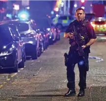  ?? PHOTO: DOMINIC LIPINSKI/PA ?? HIGH ALERT: A policeman patrols Borough High Street.