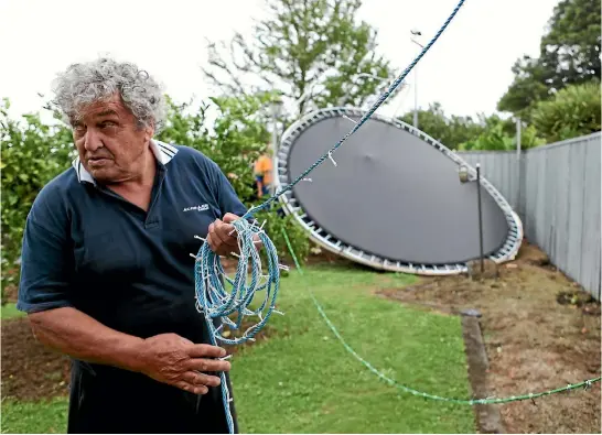  ?? PHOTO: KELLY HODEL/STUFF ?? Brian Burne woke on Friday morning to find a stray trampoline tangled among the fairy lights in his backyard.