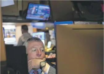  ?? SETH WENIG/AP ?? A trader at the New York Stock Exchange this month.