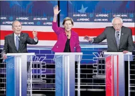  ?? John Locher Associated Press ?? MICHAEL BLOOMBERG, left, makes his first appearance on a Democratic debate stage, alongside Sens. Elizabeth Warren and Bernie Sanders, in Las Vegas.