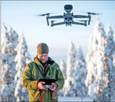  ??  ?? Daniel Viklund flies his drone in the area where his reindeers herd.