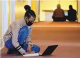  ??  ?? First-year United World College-USA student Yeabsira Bizualem of Ethiopia prepares for class in a Montezuma Castle hallway on campus.