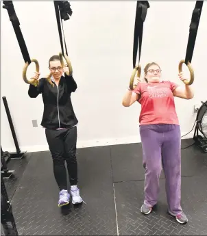  ?? Peter Hvizdak / Hearst Connecticu­t Media ?? Above: Vista Life Innovation­s students Julia, of Old Saybrook, left, and Linay, of Westbrook workout on the rings at Hammonasse­t CrossFit of Madison with Vista Life Innovation­s students on Nov. 12.