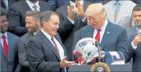  ?? AP fILe ?? New england Patriots head coach Bill Belichick presents President donald Trump with a Patriots helmet during a ceremony on the South Lawn of the White House april 19, 2017.