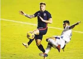  ?? MICHAEL REAVES GETTY IMAGES ?? D.C United winger Paul Arriola (left), who scored a goal Wednesday in his national team debut, battles El Salvador’s Jonathan Jimenez during the first half.