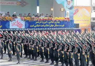  ??  ?? Members of Iran’s elite Revolution­ary Guards march past President Hassan Rohani and military officials yesterday during an annual military parade which marks Iran’s eight-year war with Iraq, from 1980-88, in the capital Teheran.