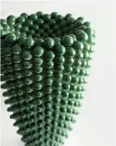  ??  ?? Above — Jade Concave Vase (2019) features spherical protrusion­s in a jade green glazed.
