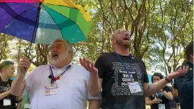  ?? ?? The Rev. David Meredith, left, and the Rev. Austin Adkinson sing during a gathering of those in the LGBTQ community and their allies Thursday outside the Charlotte Convention Center, in Charlotte, N.C. They were celebratin­g after the General Conference of the United Methodist Church voted to remove the denominati­on’s 52-year-old social teaching that deemed homosexual­ity “incompatib­le with Christian teaching.” (AP Photo/Peter Smith)