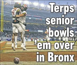  ?? Getty Images ?? WHAT A CATCH! Darryl Jones (left) is congratula­ted by QB Taulia Tagovailoa after the senior’s second TD catch in Maryland’s Pinstripe Bowl victory.