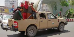  ?? AP ?? Taliban fighters pose on the back of a vehicle in the city of Herat, west of Kabul. —