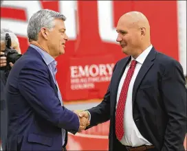  ?? CURTIS COMPTON/AJC 2018 ?? Hawks owner Tony Ressler (left) and general manager Travis Schlenk talk after introducin­g Lloyd Pierce as the team’s coach in 2018. Now Pierce is out without having had a real chance to mold the team Schlenk put together.