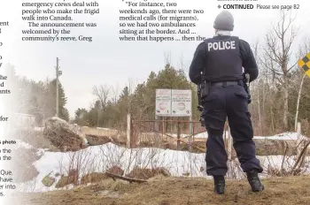  ?? Canadian Press photo ?? A police officer looks over into the United States as she stands on the Canadian side of the border Thursday near Hemmingfor­d, Que. A growing number of people have been walking across the border into Canada to claim refugee status.