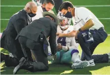  ?? Smiley N. Pool / TNS ?? Dallas Cowboys quarterbac­k Dak Prescott receives medical attention after being injured in the third quarter.