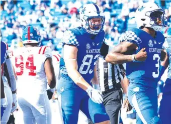  ?? UNIVERSITY OF KENTUCKY PHOTO ?? Kentucky senior quarterbac­k Terry Wilson celebrates a touchdown during the 42-41 overtime loss to Ole Miss in Lexington on Oct. 3.