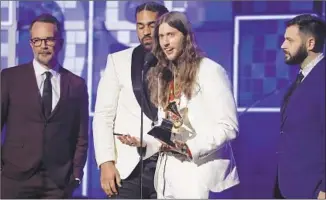  ??  ?? LUDWIG Goransson, center, accepts the record of the year award in Childish Gambino’s absence.