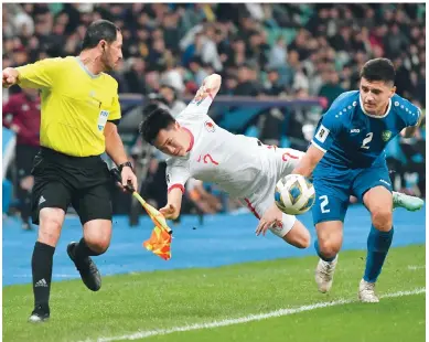  ?? Photo: AP ?? Hong Kong’s Jessie Yu Joy-yin goes flying in a clash with Uzbekistan’s Abdukodir Khusanov during their World Cup qualifier in Tashkent.