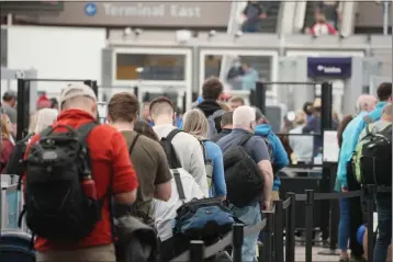  ?? DAVID ZALUBOWSKI — THE ASSOCIATED PRESS, FILE ?? Travelers queue up at the north security checkpoint in the main terminal of Denver Internatio­nal Airport, on May 26, in Denver.