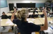  ?? REED SAXON — THE ASSOCIATED PRESS ?? In this Friday, July 13, 2018 photo, teacher Zara Gibbon gestures while teaching a group of incoming sixth-graders at Animo Westside Charter Middle School during a summer session to introduce new students to the school they will attend in the fall, in the Playa Del Rey area of Los Angeles.