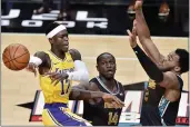  ?? BRANDON DILL — THE ASSOCIATED PRESS ?? Los Angeles Lakers guard Dennis Schroder passes against Memphis Grizzlies center Gorgui Dieng and forward Xavier Tillman in the second half Tuesday.