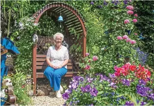  ??  ?? Leafy retreat: Myra Tucker enjoying the results of all her hard work