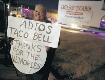  ?? Michael Robinson Chavez
Los Angeles Times ?? DEB BAILEY of Burbank is among the 50 or so fans who came to see the building’s departure from Downey on Thursday night. Taco Bell founder Glen Bell opened the 400-square-foot eatery in 1962.