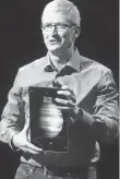  ?? JEFFERSON GRAHAM, USA TODAY ?? Apple CEO Tim Cook addresses the crowd at an Apple event in 2015, holding a new iPad Pro.