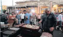  ?? KHALED ELFIQI EPA-EFE African News Agency (ANA) ?? SHOPPERS gather around boxes of fish displayed for sale at a market. Egypt consumes 1.8 million tons of fish annually. |