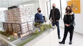  ?? COLE BURSTON FOR THE TORONTO STAR ?? From left, developer Michoel Klugmann, architect Charles Gane, and interior designer Elaine Cecconi with the scale model for Perch Condos coming to the former site of the Knight’s Inn on Kingston Road in Scarboroug­h.