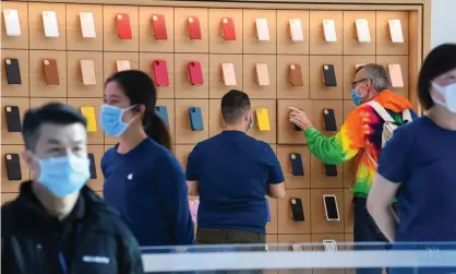  ?? Photograph: James D Morgan/Getty ?? Apple staff work at the flagship store in Sydney, Australia.