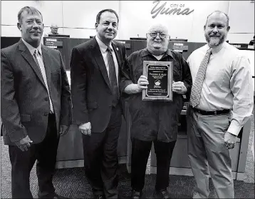  ?? PHOTO BY MARA KNAUB/YUMA SUN ?? JOHN ALLT accepts a plaque commemorat­ing his late father, Thomas F. Allt, who served as mayor of Yuma from 1963 to 1973. On Wednesday, the City Council named the new Utilities Department facility, to be located at 200 W. 13th St., the “Thomas F. Allt Utilities Complex.”