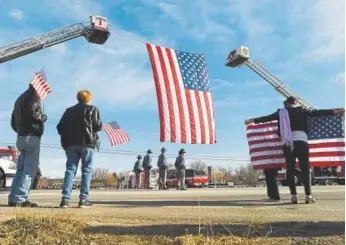  ?? RJ Sangosti, The Denver Post ?? People line the street during a procession to LifeBridge Church for Cpl. Daniel Groves on Thursday in Longmont. Groves died when he was struck by a vehicle while responding to a motorist in Weld County during last week’s blizzard.