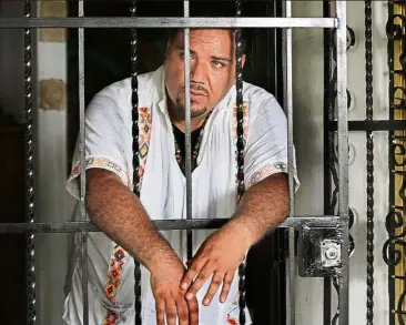  ??  ?? Soni standing behind the wrought iron door of his house in Tanquian de Escobedo, San Luis Potosi, Mexico. —AP