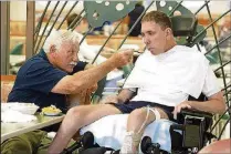  ??  ?? Howard feeds son Stephen Schnellenb­erger, who battled substance addiction before dying from Hodgkin lymphoma in 2008.