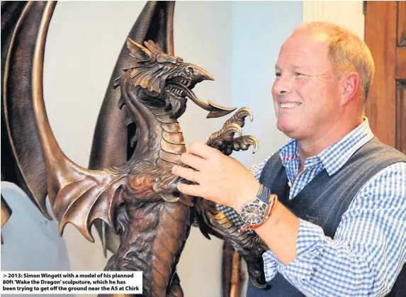  ??  ?? > 2013: Simon Wingett with a model of his planned 80ft ‘Wake the Dragon’ sculputure, which he has been trying to get off the ground near the A5 at Chirk