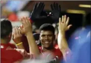  ?? MATT SLOCUM - AP ?? The Washington Nationals’ Juan Soto celebrates with teammates in the dugout after hitting a two-run home run during the fourth inning of the second game of a doublehead­er against the Phillies, Tuesday. The Nationals used a three-run 9th inning to tie the game 6-6, forcing the game to end after this edition’s deadline.