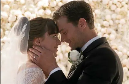  ?? UNIVERSAL PICTURES ?? Dakota Johnson’s Anastasia and Jamie Dornan’s Christian are wed early in “Fifty Shades Freed.”