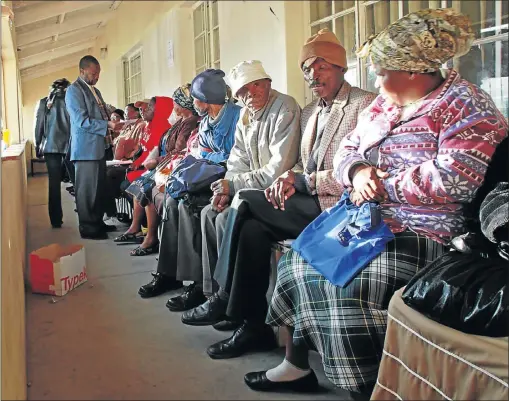  ?? Picture: GARY HORLOR ?? Grant recipients wait for payouts at the South African Social Security Agency office in Mdantsane. Now retailers are urging banks to drop payout fees to accommodat­e recipients.