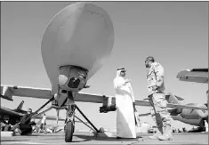  ?? — Photo by The Associated Press ?? In this 2007 file photo, an Emarati visitor asks a U.S. military representa­tive questions, as they stand next to an MQ-1 Predator spy plane, during the second day of the 10th Dubai Airshow, at the Dubai airport, United Arab Emirates.