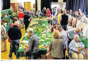  ??  ?? Busy Visitors peruse the tables packed with lovely produce. Pics: Robert Harrison