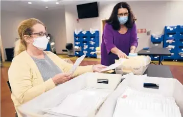  ?? SETH WENIG/AP ?? Ann Carlette, left, processes mail-in ballots Wednesday for Bergen County in Hackensack, New Jersey.