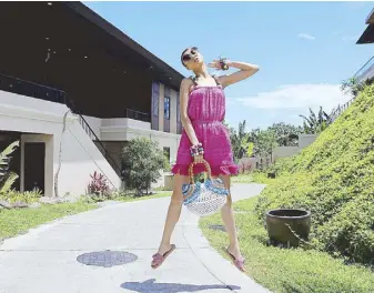  ??  ?? Dress and bangles by Good Luck, Humans; handbag by Tali Handmade; and slip-ons by Elinora. Photograph­y by JO ANN BITAGCOL • Styling by LUIS ESPIRITU JR • Makeup and hairstylin­g by BABA PARMA • Model: IMARI RODRIGUEZ of Mercator • Special thanks to the...